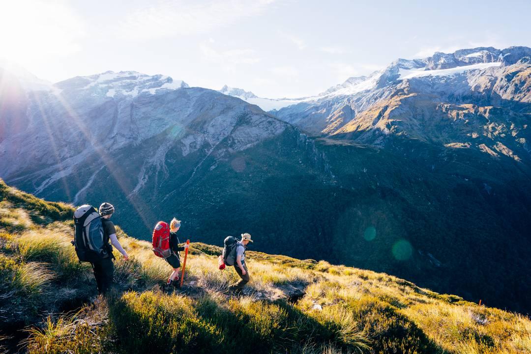 Three people hiking Matukituki Valley.