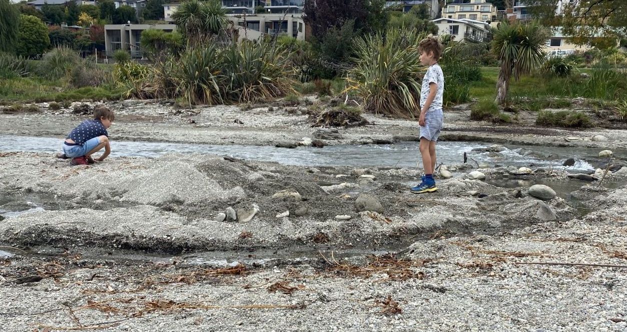 Kids playing on beach in Wanaka.