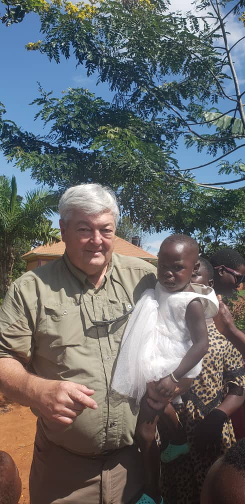 Jim Forbis with a child in Uganda