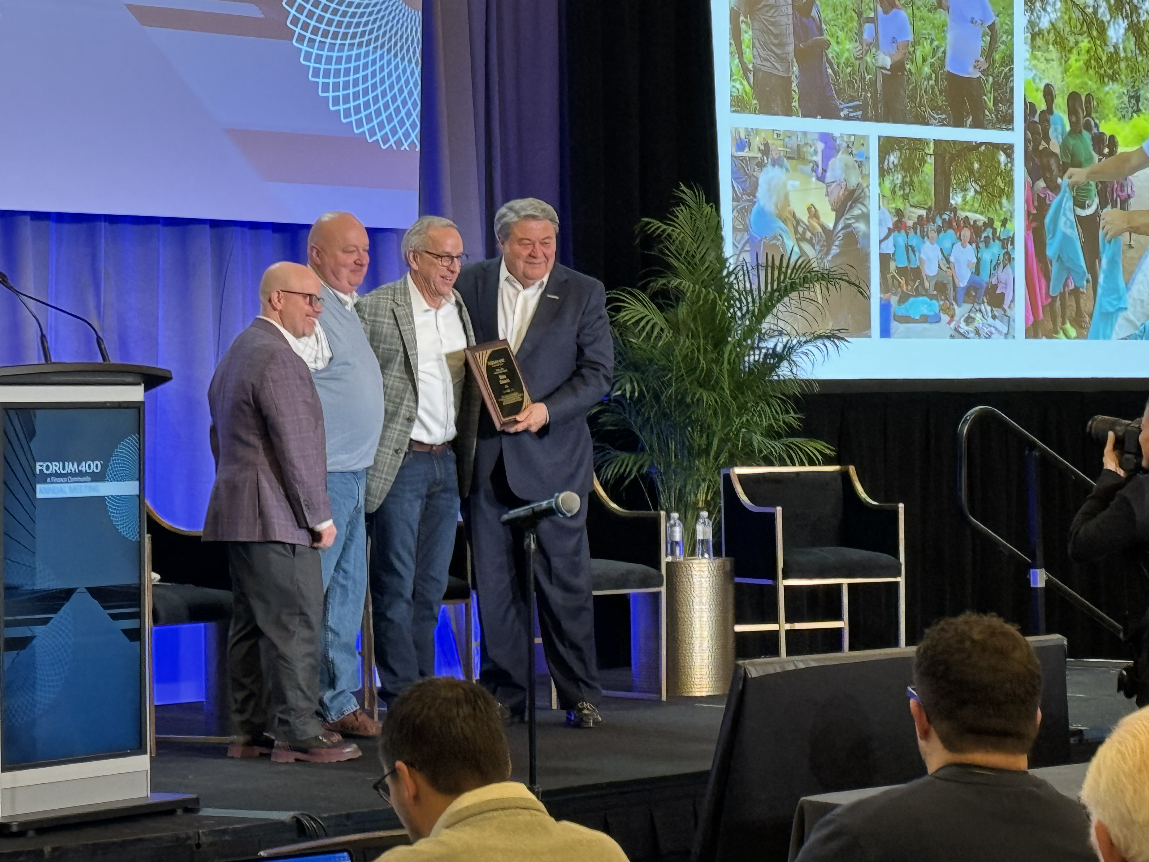 Mike Owens receiving the Forum 400 Humanitarian Award on stage