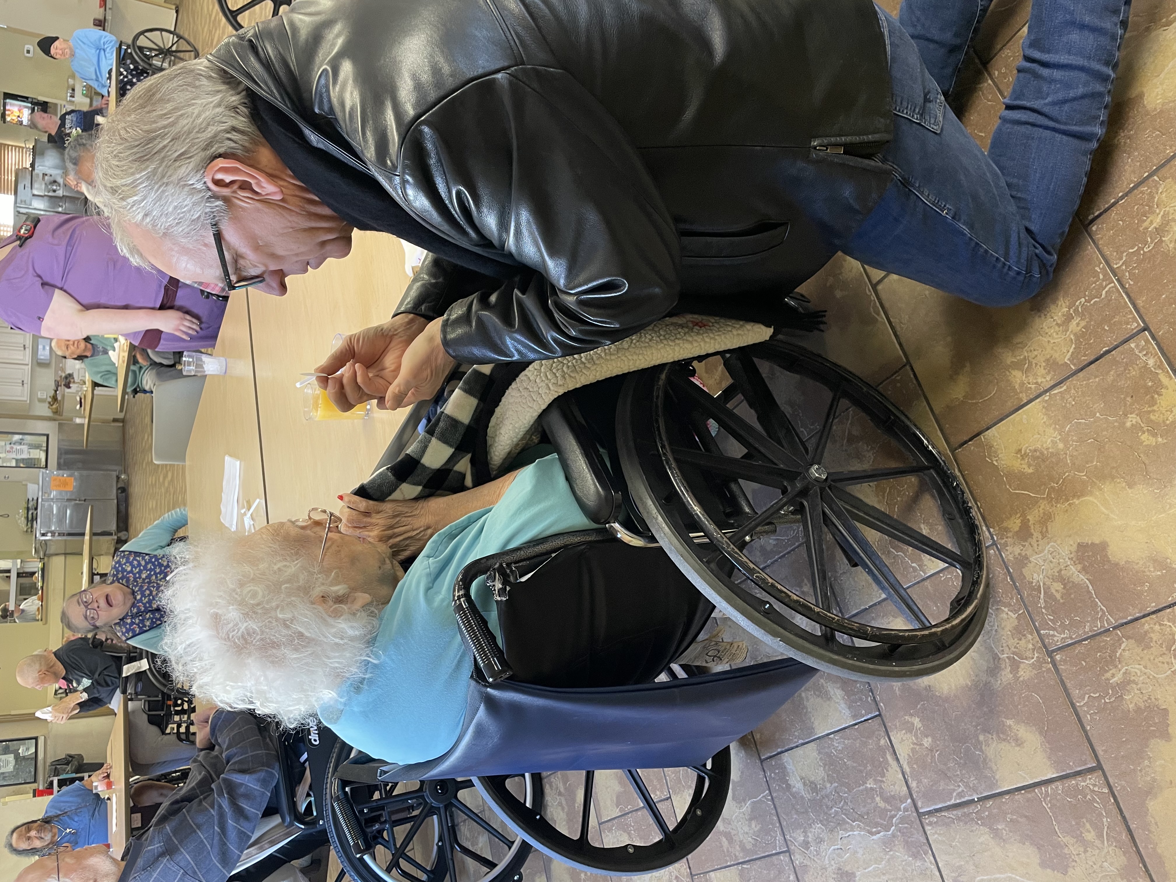 Mike Owens bringing Holy Communion to a hospice resident