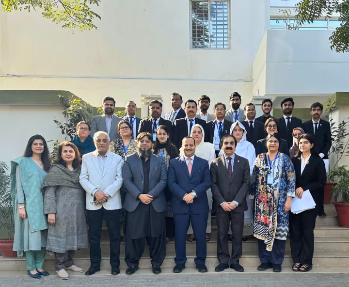 Dr. Emad Hussein with legal professionals and delegates outside a building during an international event.