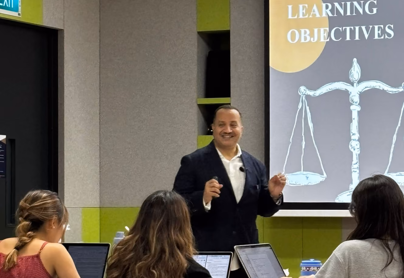 Dr Emad Hussein lecturing to a room of students and professionals
