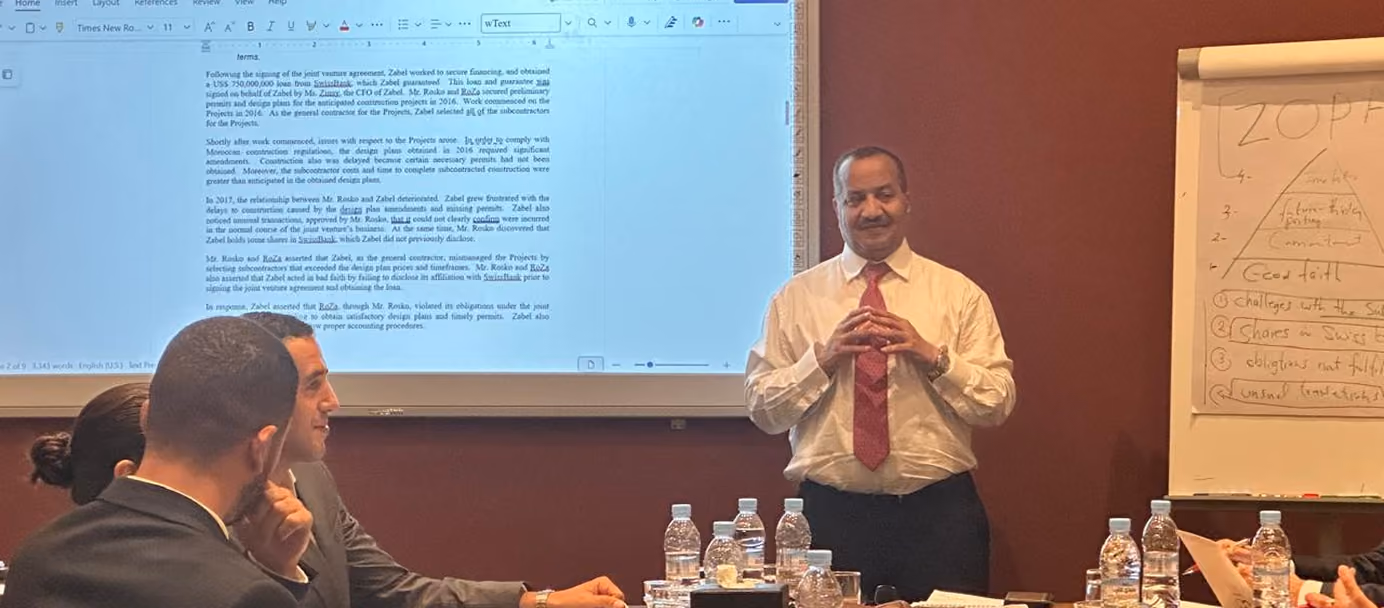 Dr. Emad Hussein leading a negotiation workshop built around a joint venture dispute case study