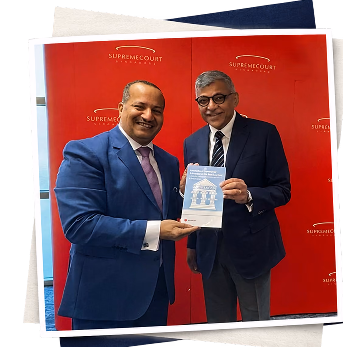 Dr Emad Hussein exchanging his publication with a fellow practitioner