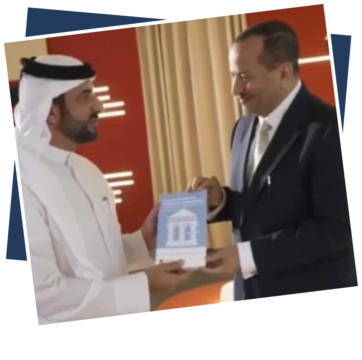 Dr Emad Hussein exchanging his publication with a fellow practitioner