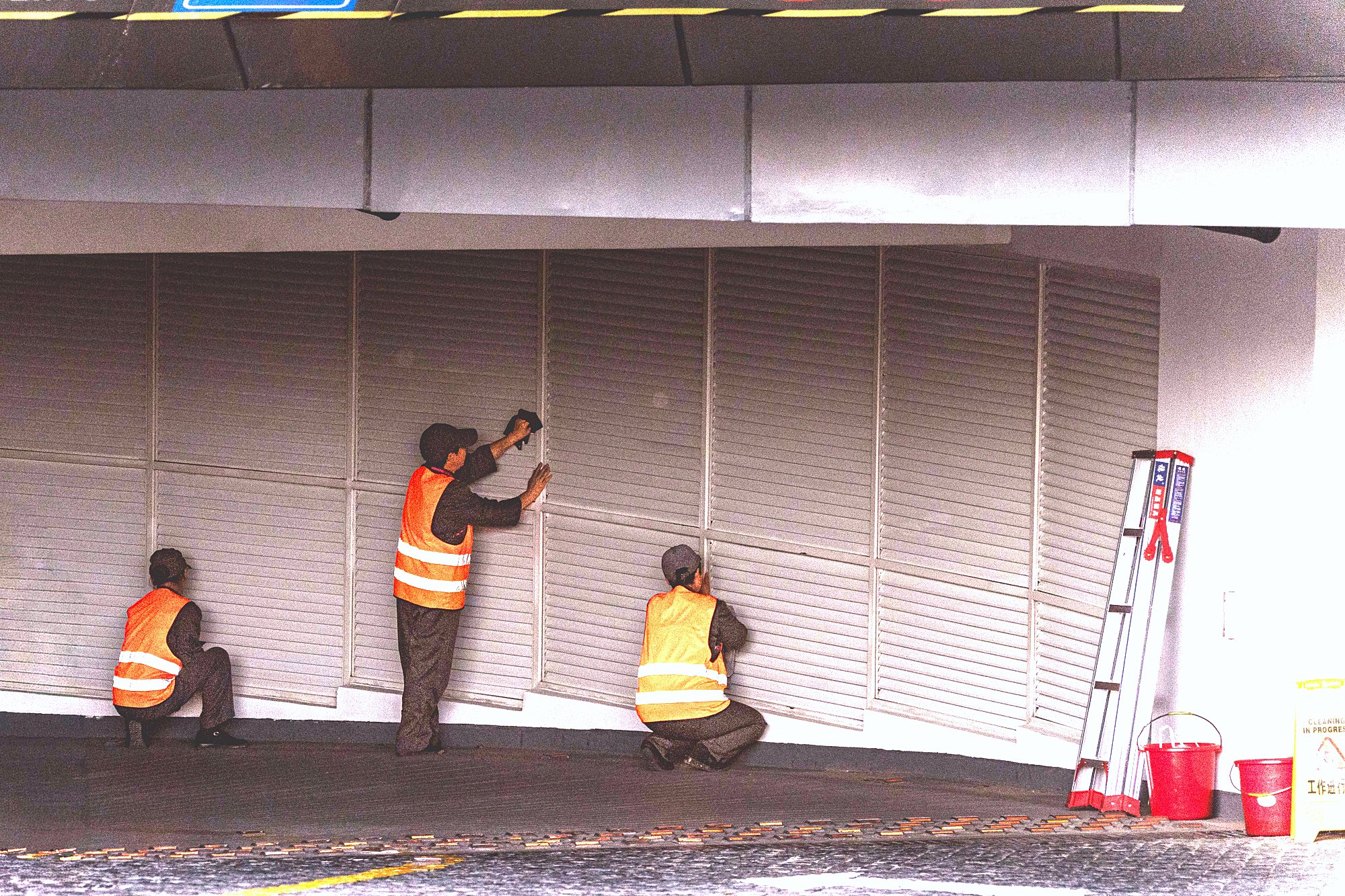 Workers carrying out remedial work to a concrete soffit on a building site