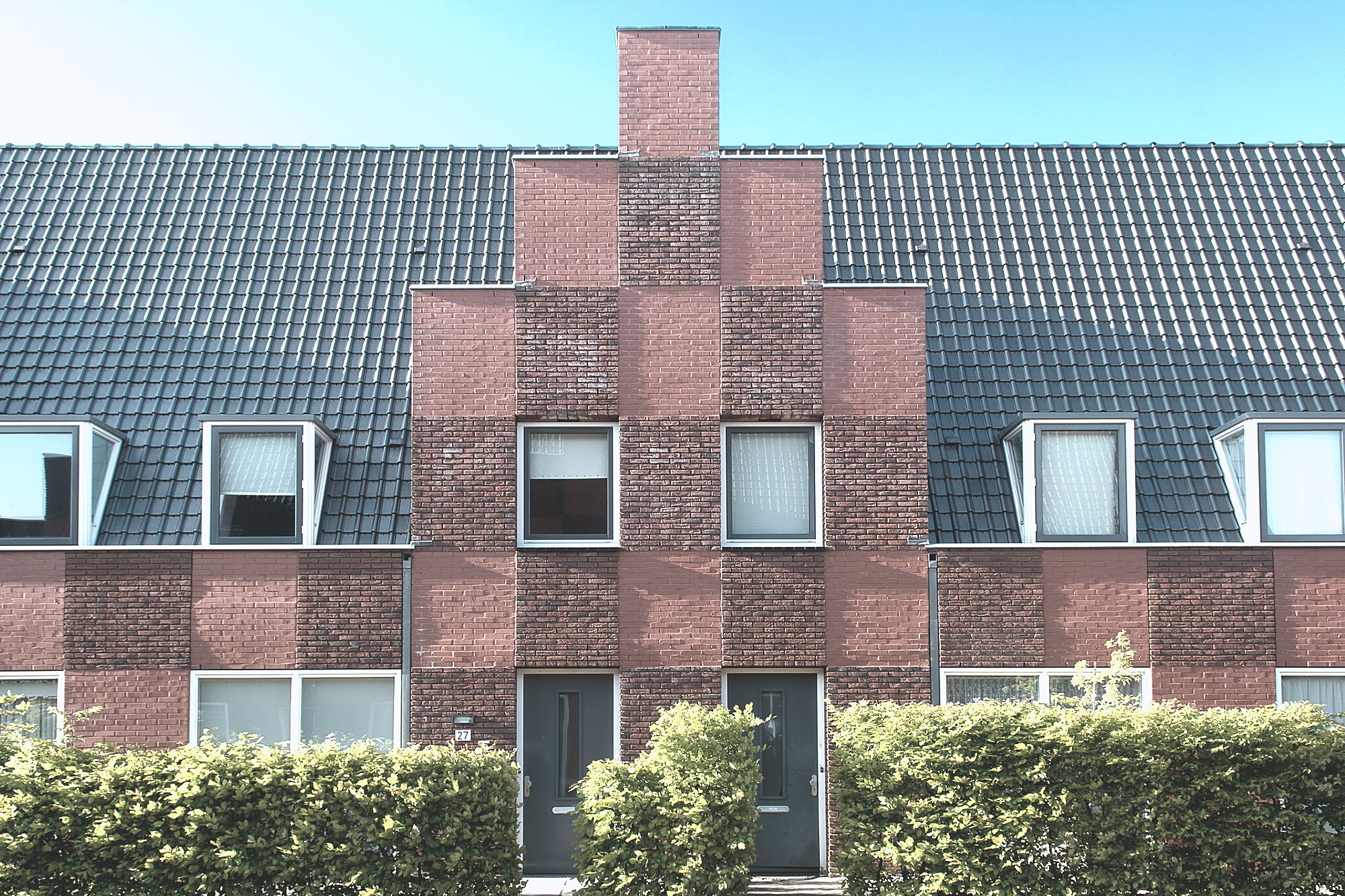 Row of brick terrace homes with tiled roofs