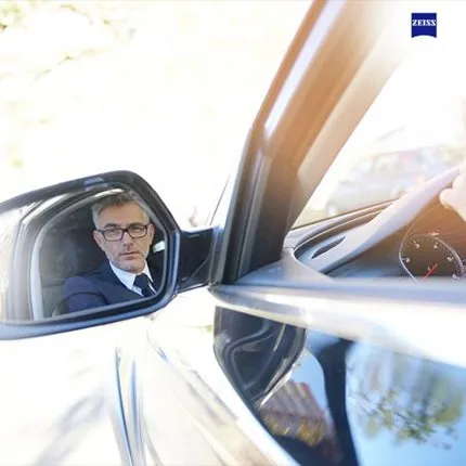 A man in a revision mirror using the ZEISS DriveSafe Lenses