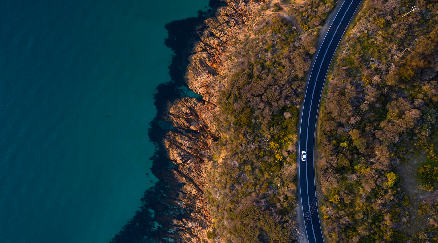 Aerial photo of a rental car on an Australian road