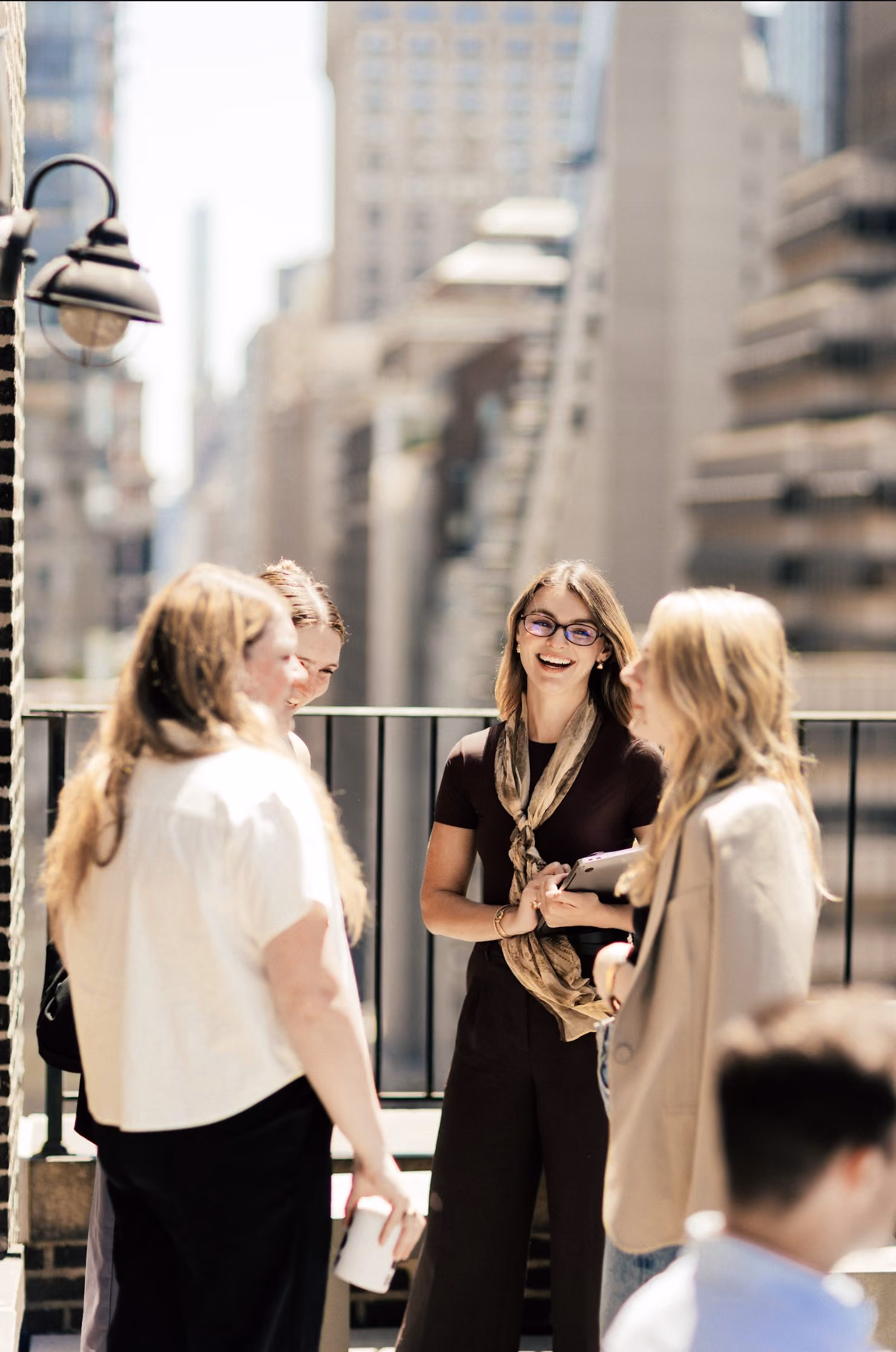 Executives in conversation on a rooftop terrace