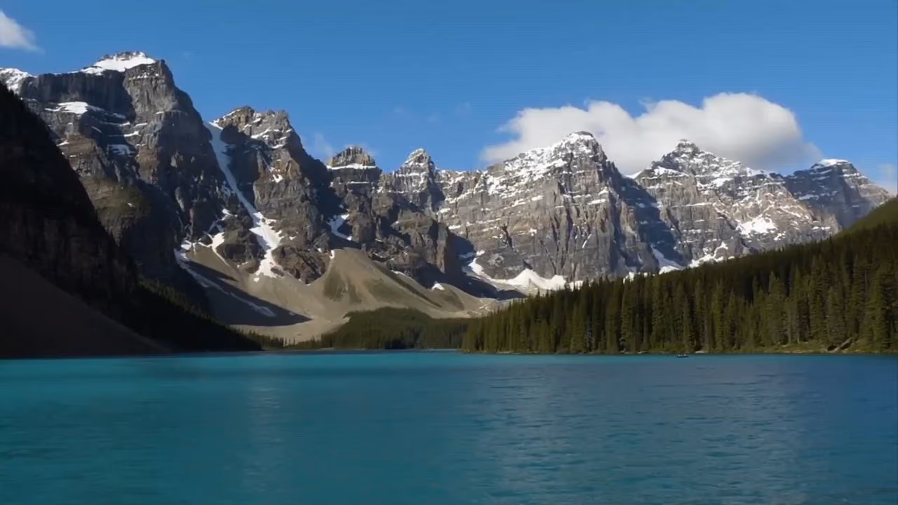 Snow-capped mountains above a turquoise glacial lake in Banff