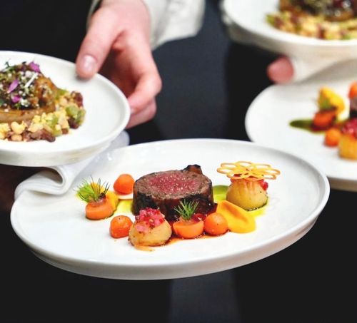 Chef finishing a plate before service
