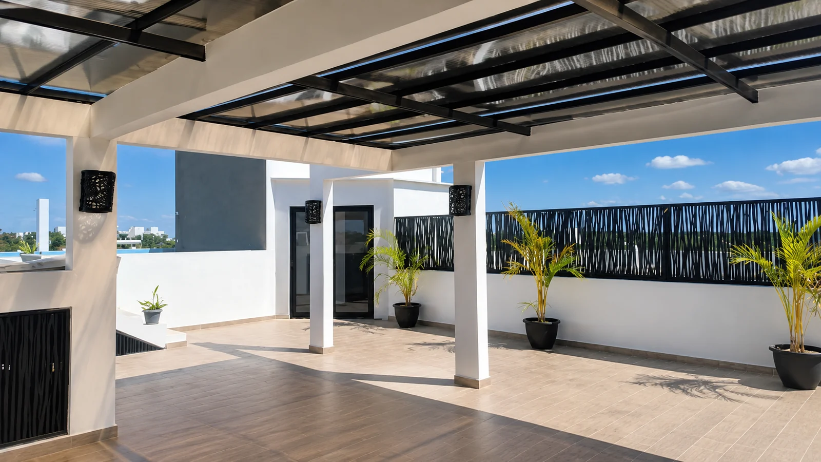 The covered shared rooftop terrace at Quince Sur