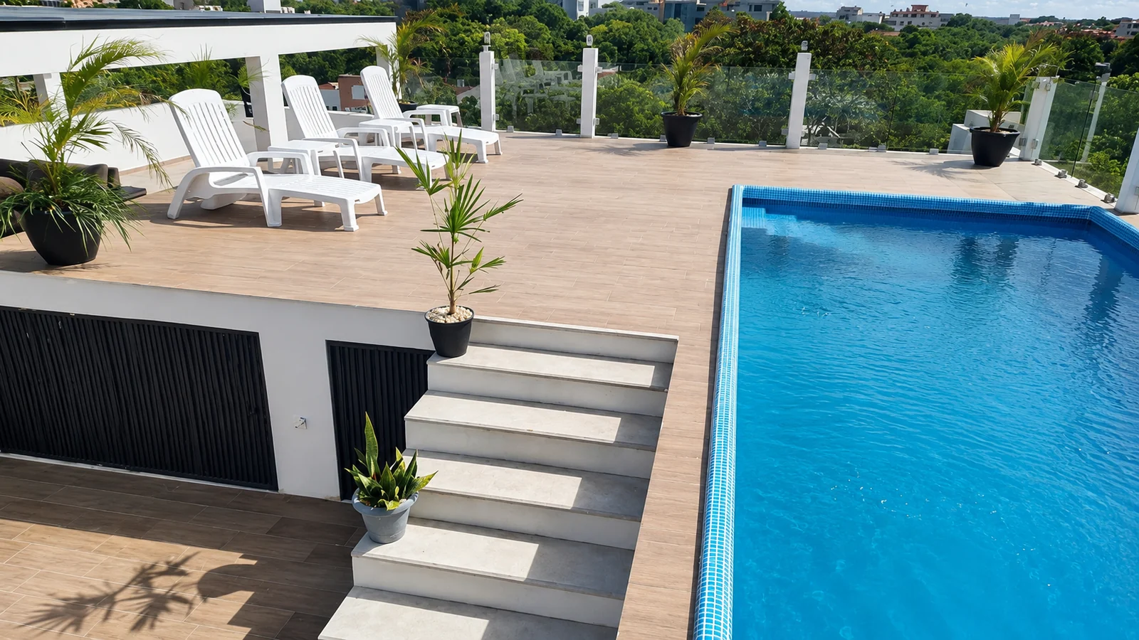 Shared rooftop pool deck and lounge chairs at Quince Sur