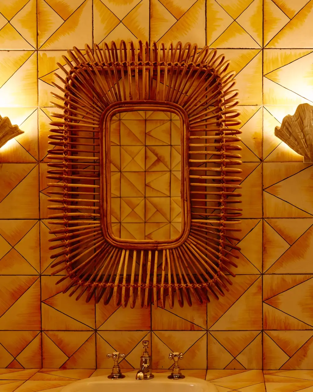 Woven rattan wall art and geometric patterned yellow tiles.