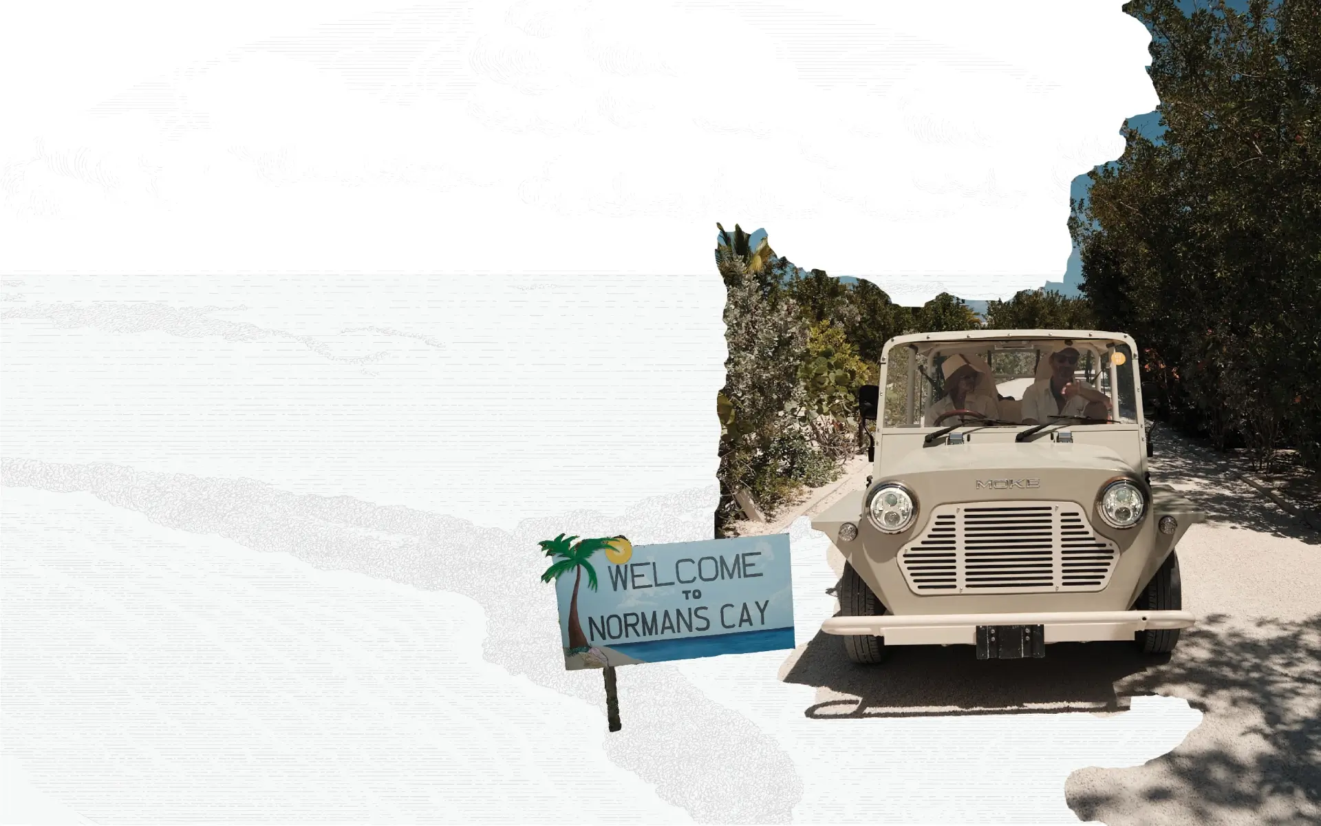 Two people riding in a beige vintage-style open vehicle on a shaded gravel path surrounded by dense greenery, with a sign that reads 'Welcome to Normans Cay' featuring a palm tree and sun illustration.