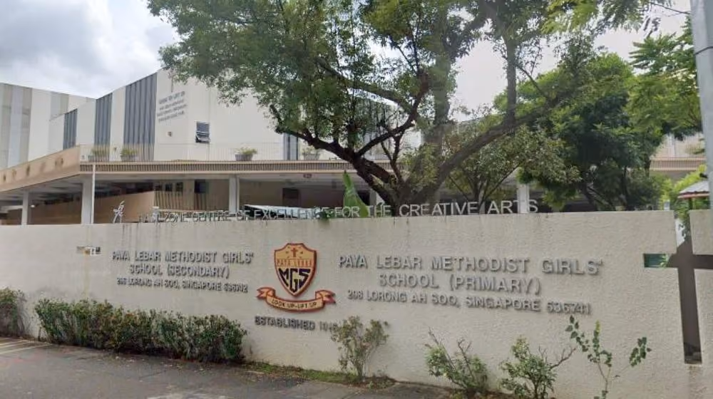 Entrance wall of Paya Lebar Methodist Girls School with logo and school names for secondary and primary levels.