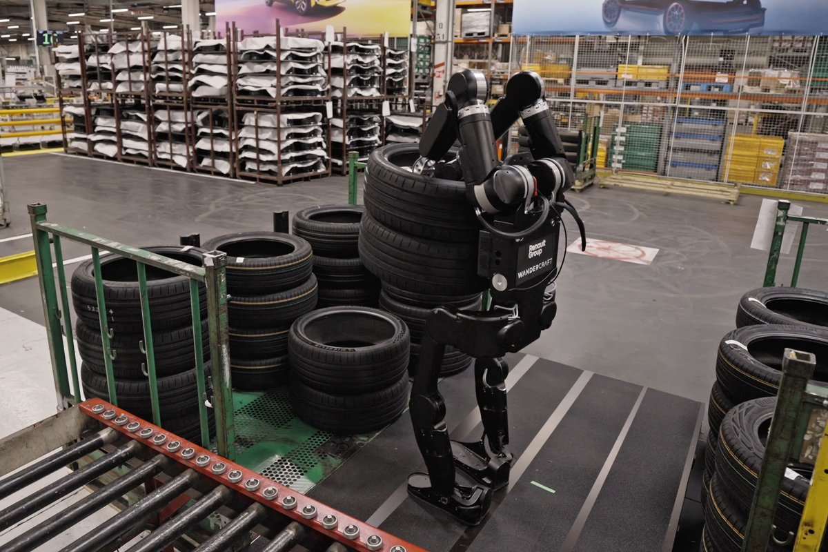 Calvin-40 carrying a stack of tyres on the floor of a Renault plant