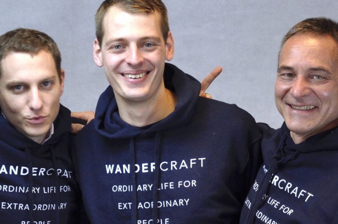 Wandercraft's founders together in the company's early days, wearing Wandercraft hoodies