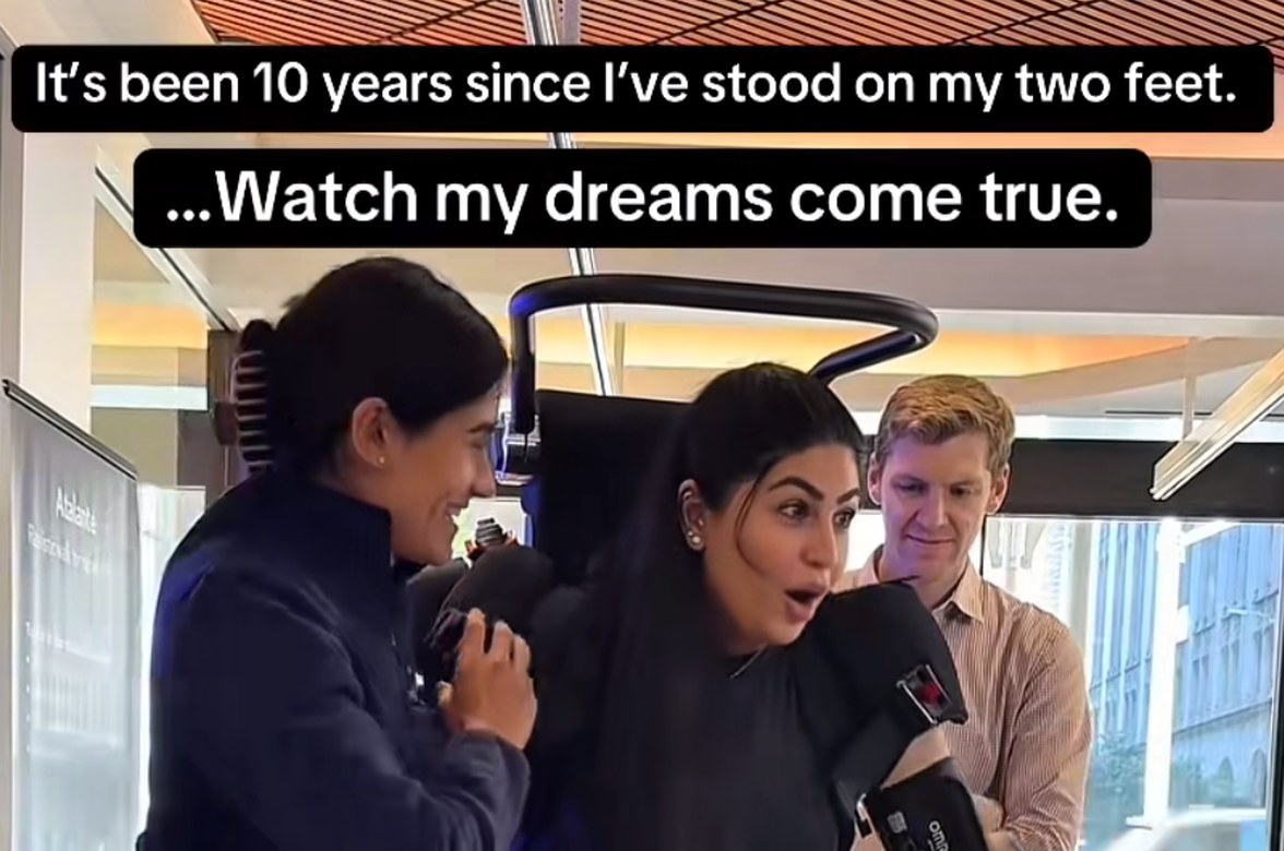 A user standing in Atalante between two clinicians, captioned “It’s been 10 years since I’ve stood on my two feet. …Watch my dreams come true.”