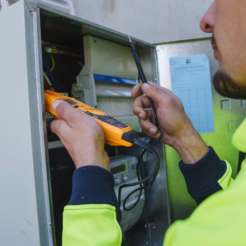 Electrician testing power supply