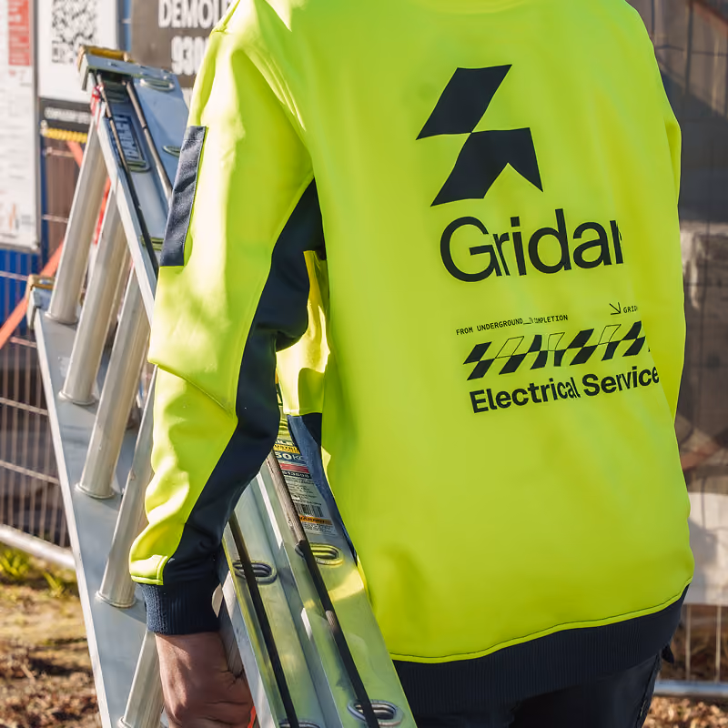 Electrician carrying a ladder