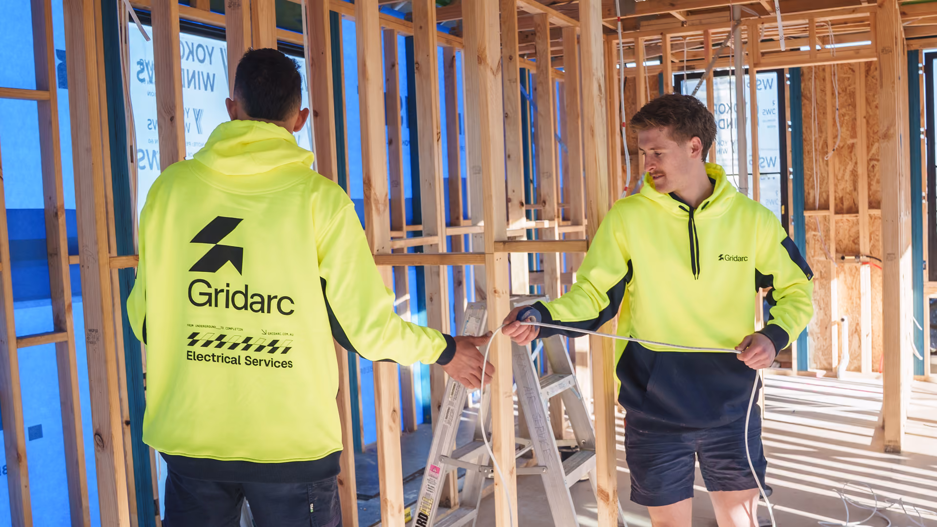 Electricians working together on site