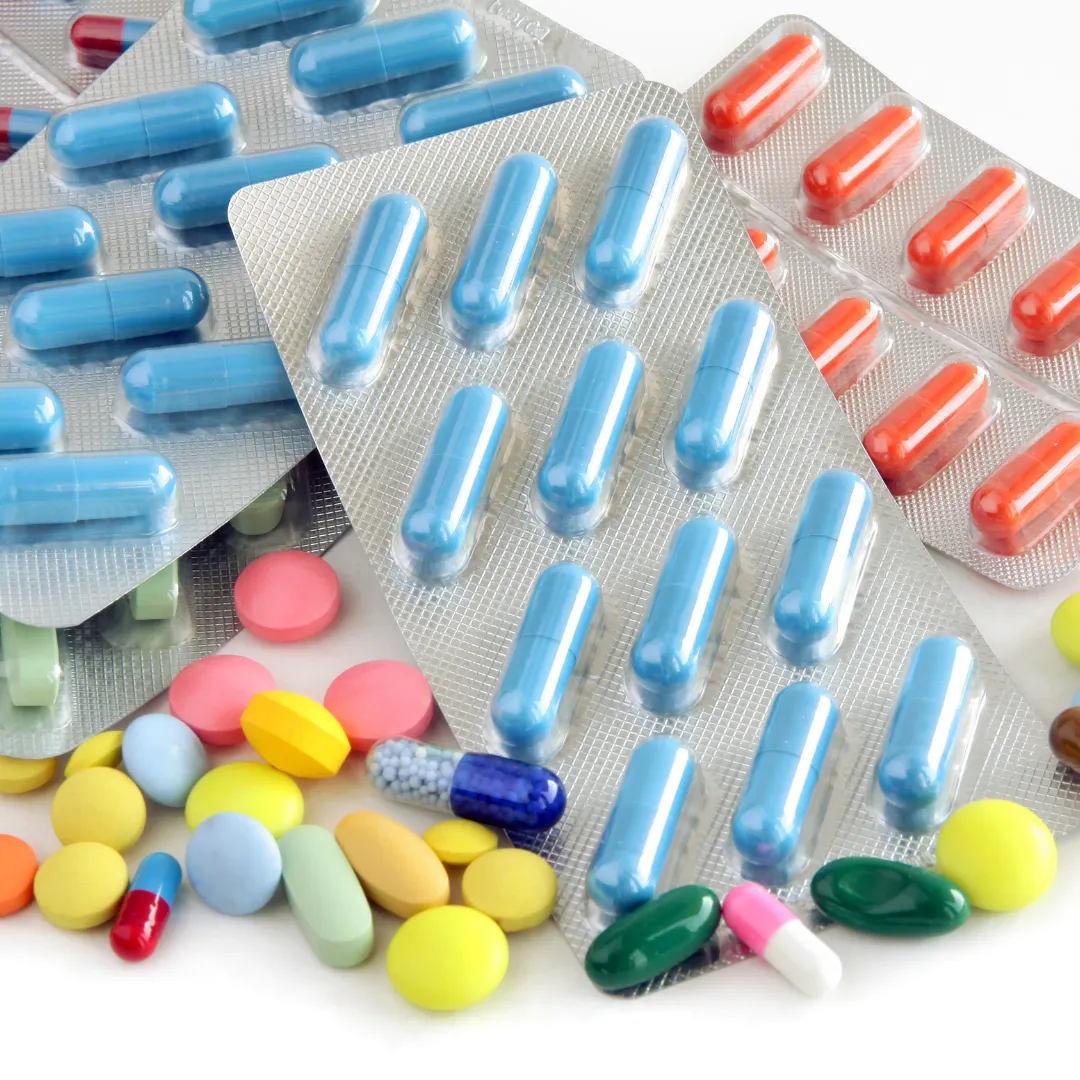 Assorted prescription pills and capsules in blister packs.