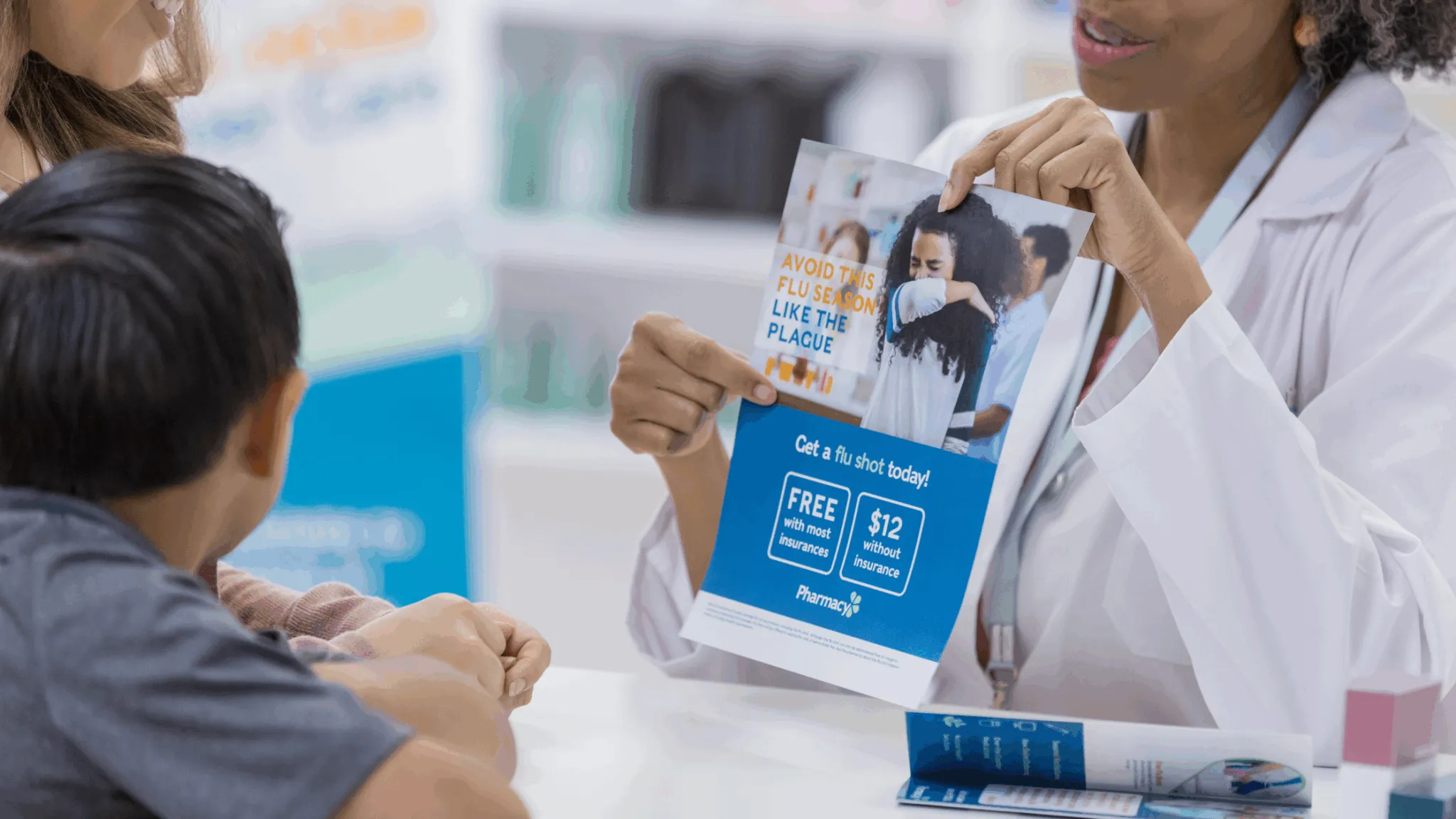A pharmacist is showing a flu shot promotion flyer to a customer.