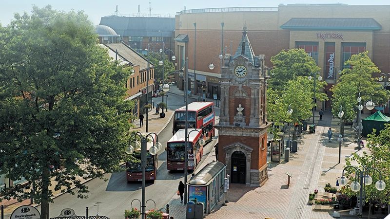 Town centre street with a red bus in Bexley