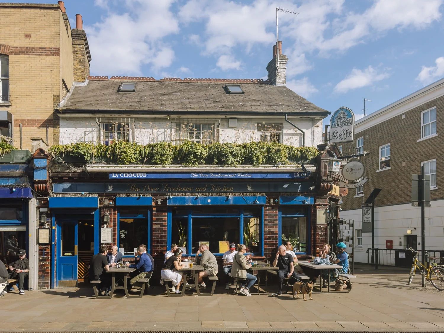 People outside a corner pub in Hackney