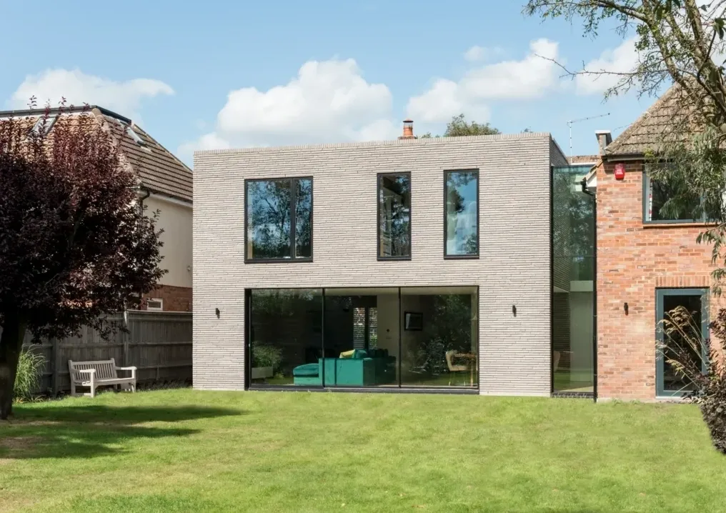 Contemporary two-storey rear extension with large glazed windows facing a garden
