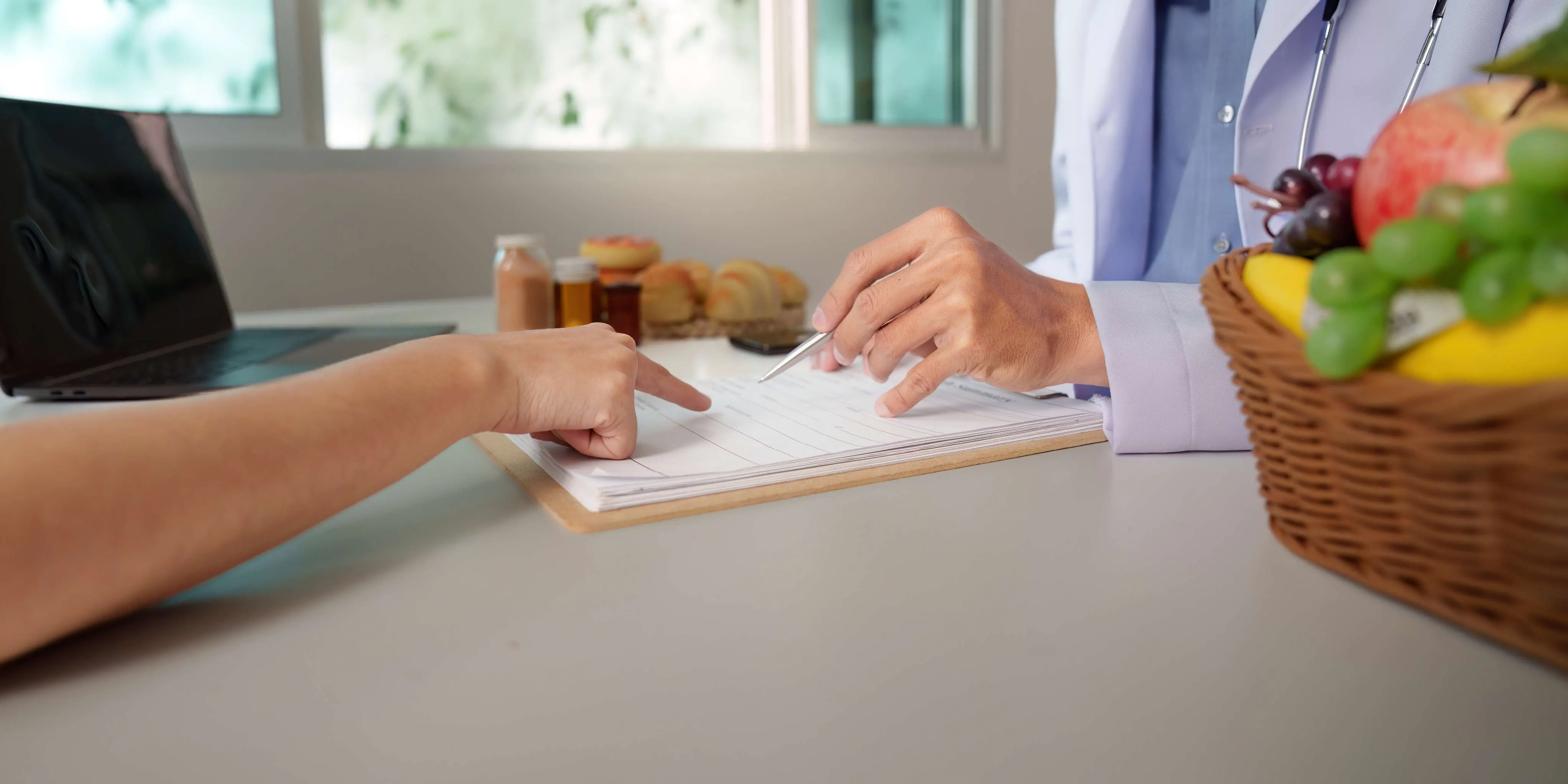 Dietitian and client going over a nutrition plan together at a desk