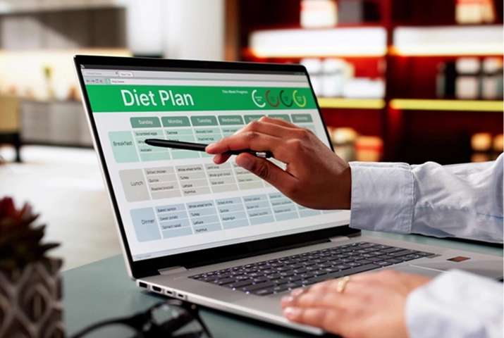 Dietitian reviewing a personalised nutrition plan on a laptop