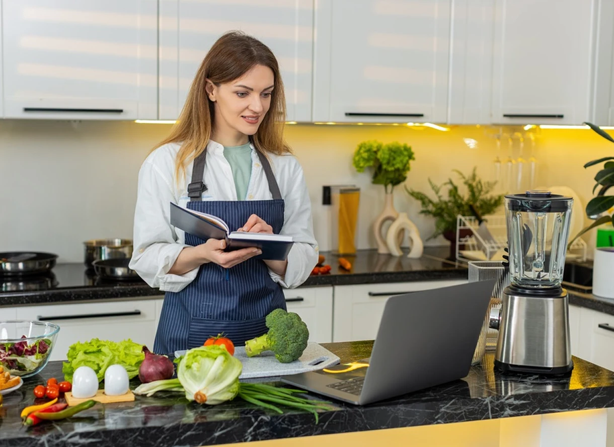 Dietitian using a tablet and laptop while reviewing nutrition information