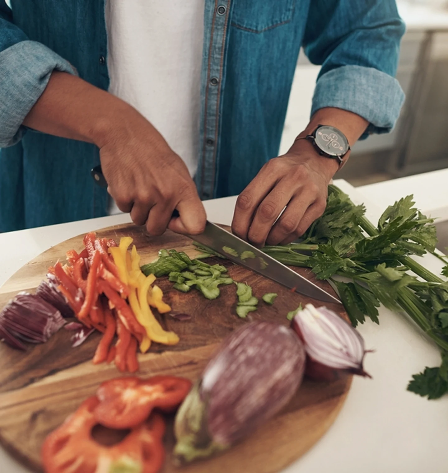 Hands chopping colourful vegetables for a nutritious home-cooked meal