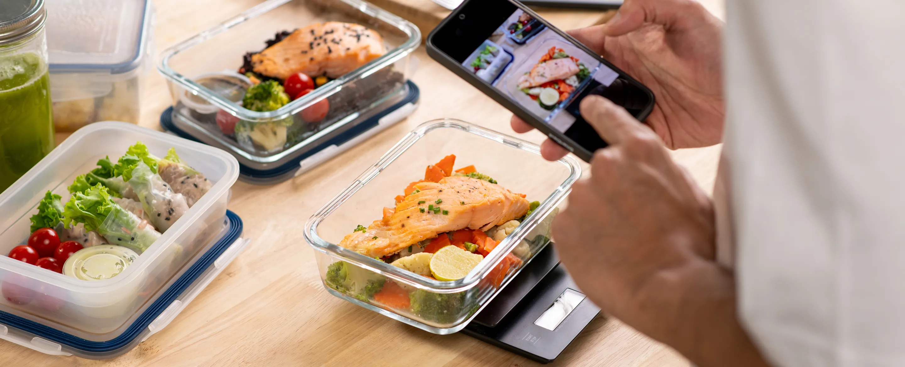 Person using a phone to track prepared meals and healthy food choices
