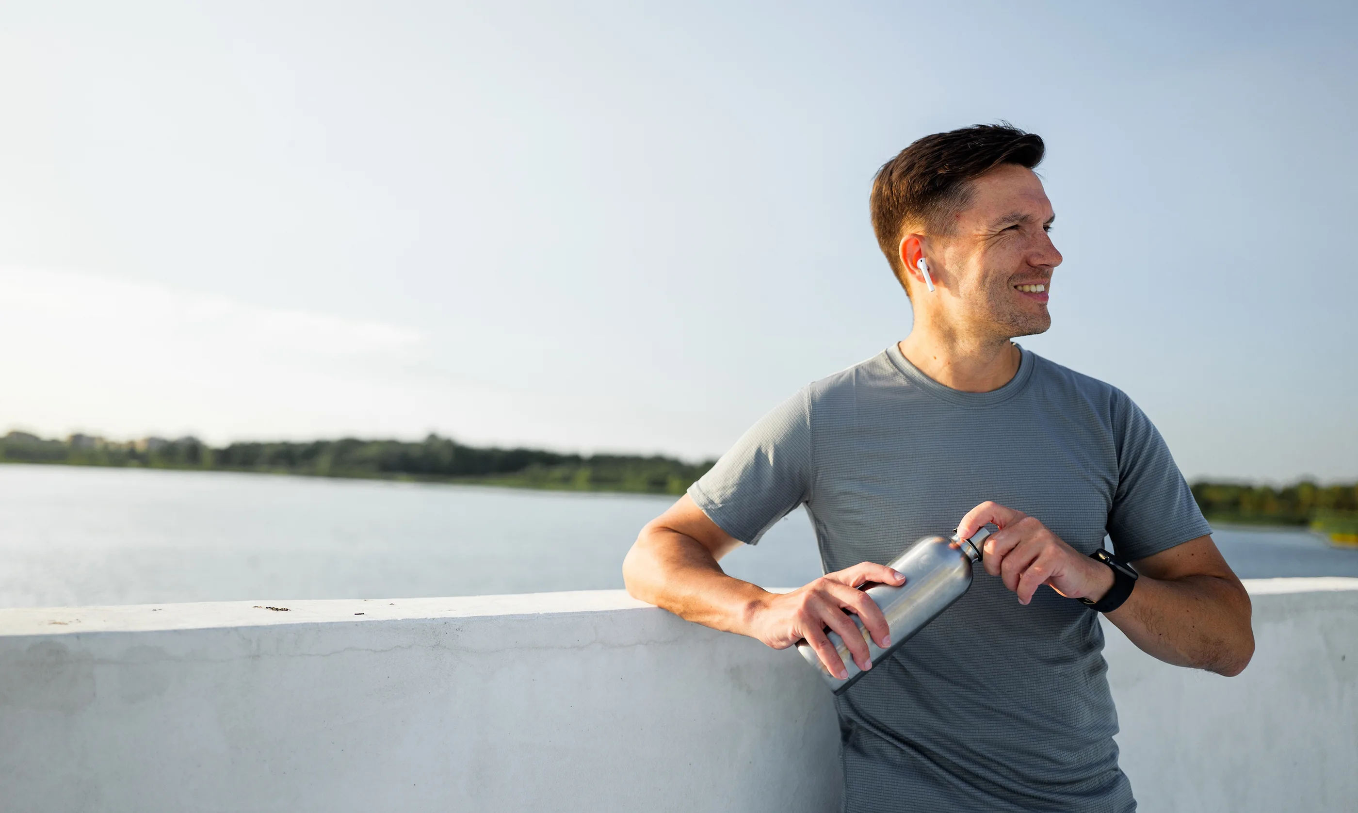 Active man pausing during an outdoor run as part of a healthy lifestyle
