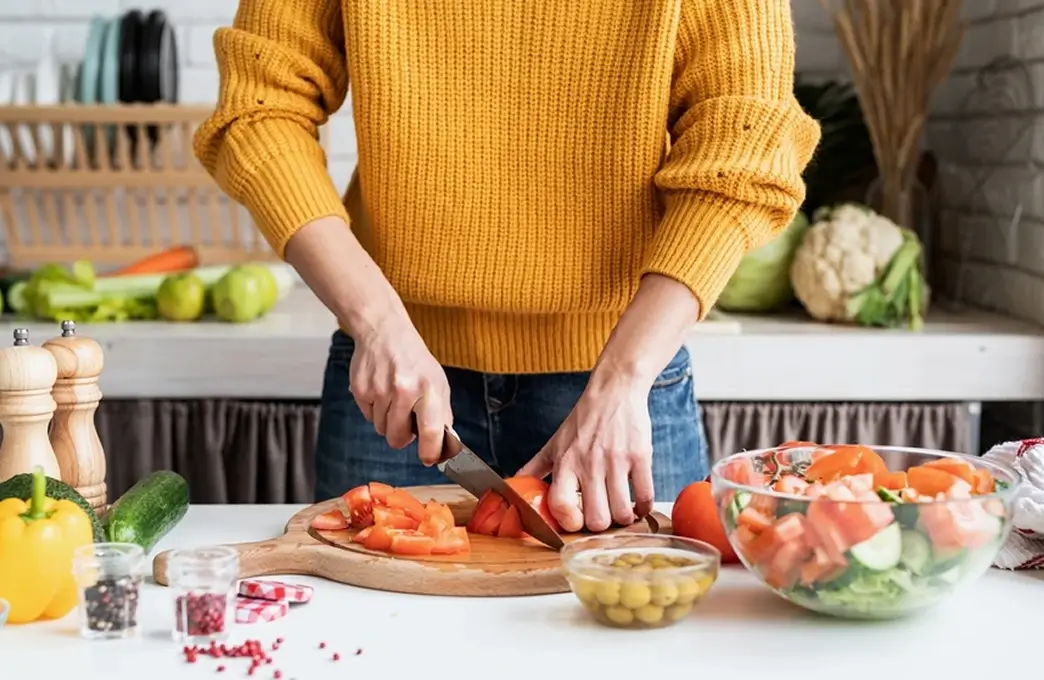 Woman preparing vegetables and a balanced meal with nutrition guidance