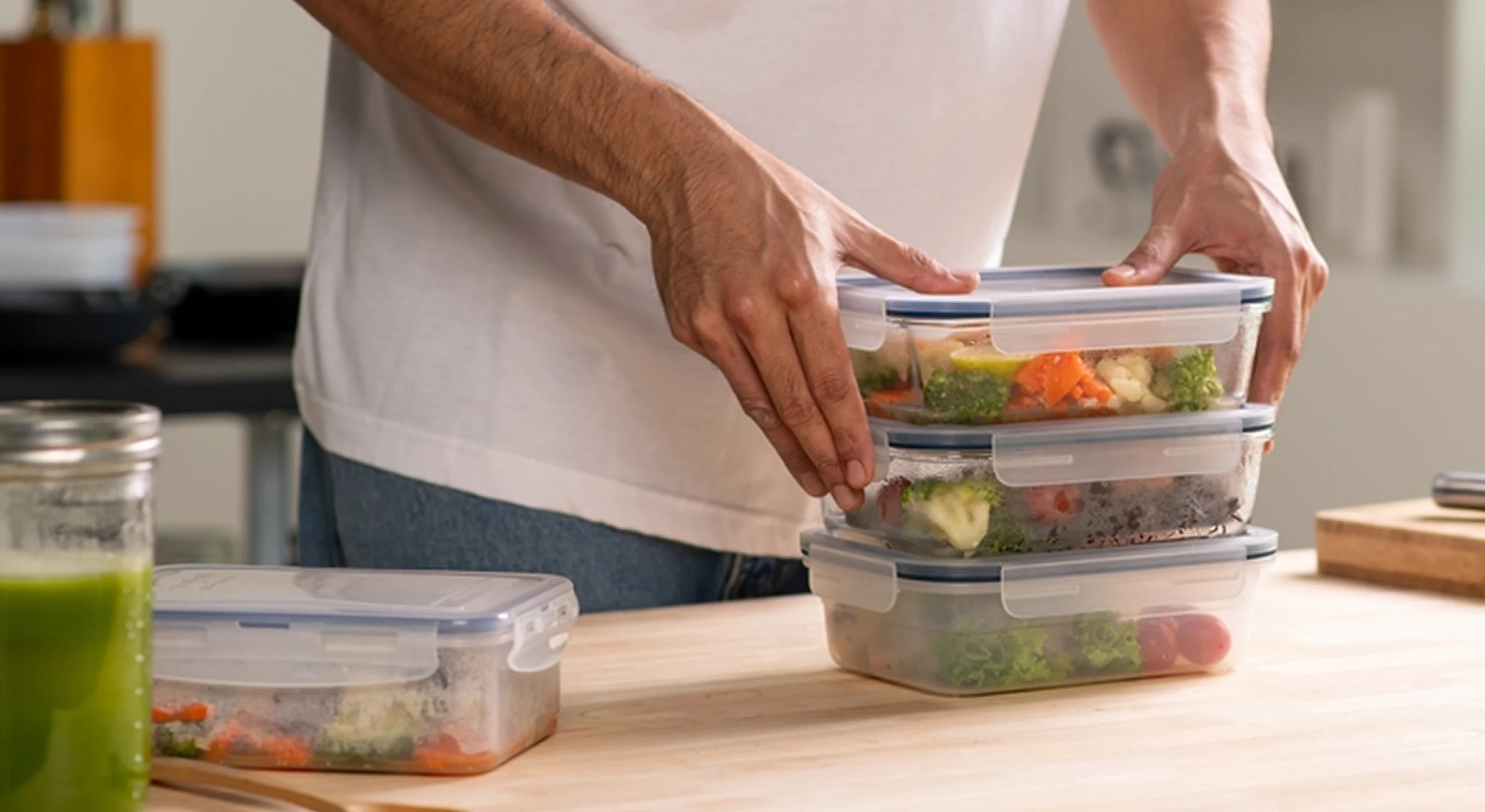 Man organising healthy meal-prep containers for a personalised nutrition plan