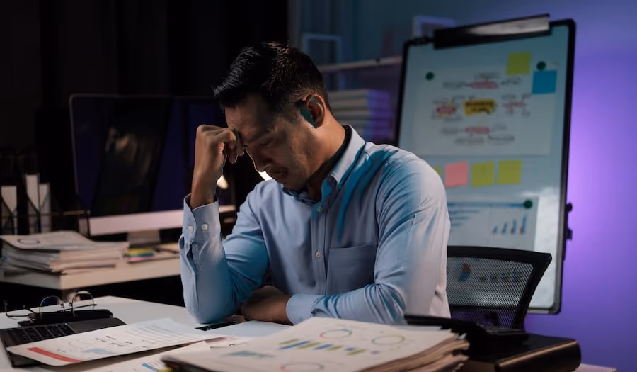 tired-and-frustrated-man-looking-at-financial-reports