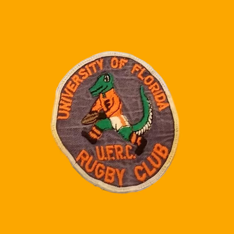 Patch with a green alligator in orange playing rugby, text: University of Florida U.F.R.C Rugby Club.