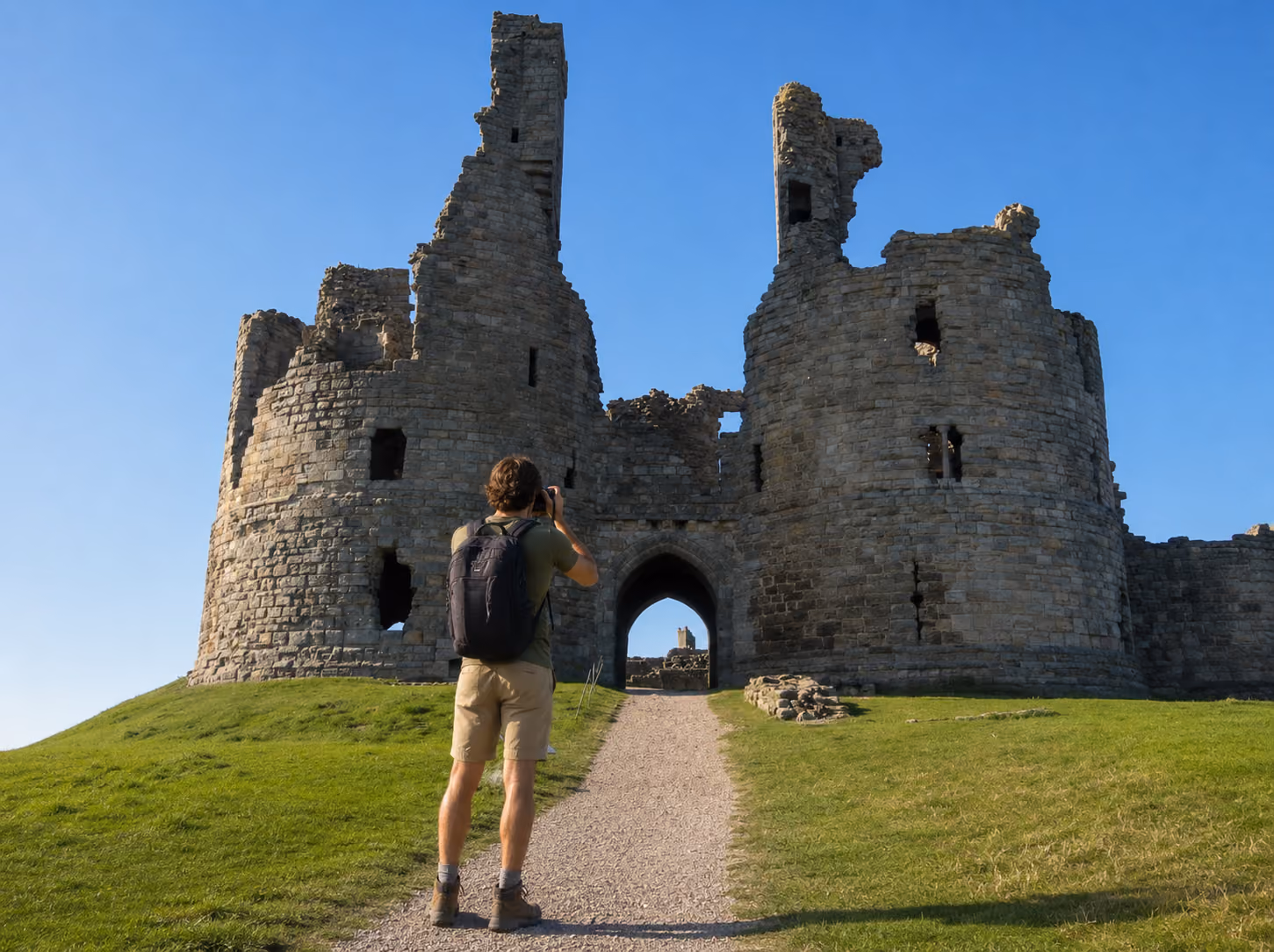 Photographer taking picture of Dunstanburgh Castle