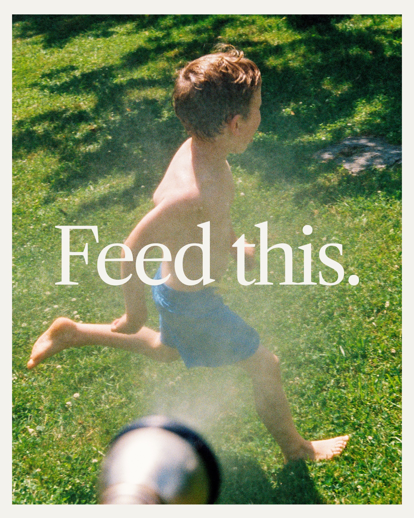A child running through a sprinkler