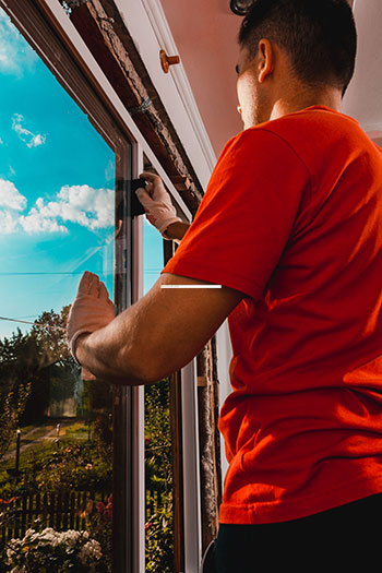 A window technician is replacting glass in a window