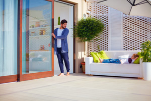 A man opens his sliding glass patio doors