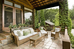 Patio with lush green foliage on columns and patio furniture overlooked by patio doors