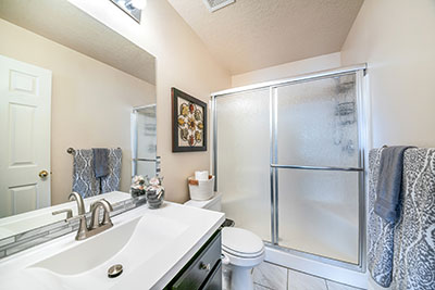 A bathroom with a frosted glass shower door
