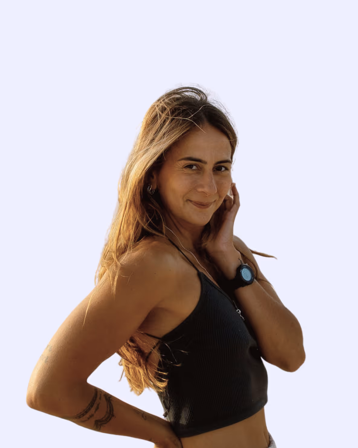 Smiling woman with long hair wearing black tank top and smartwatch, posing with hand on face and hip.